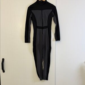 Black and gray long-sleeved athletic jumpsuit or bodysuit,  for skiing